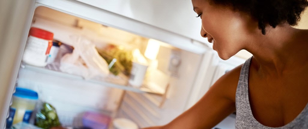 Girl opening fridge