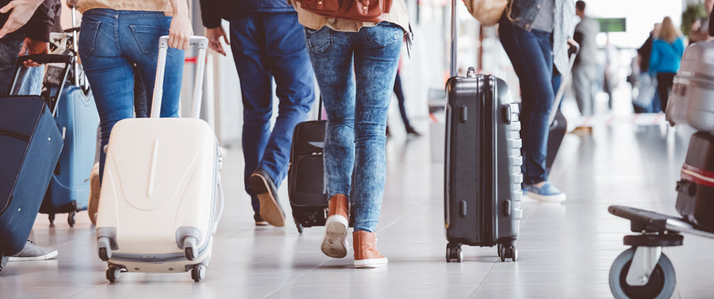 people walking with suitcases